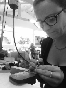 chloe michell working at her bench on a gold wedding ring 