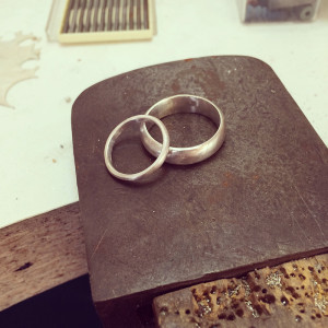 Silver prototype wedding rings to be sized by clients. one delicate female wedding ring and chunkier male wedding ring made by chloe michell jewellery