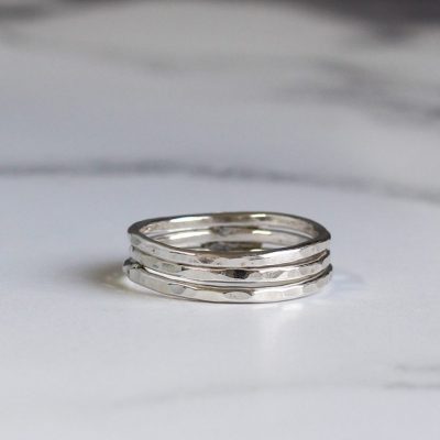 stack of sterling silver hammered stacking rings made by chloe michell jewellery