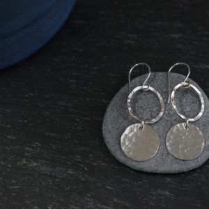 Hammered sterling silver discs hanging from silver hoops earrings made by chloe michell jewellery